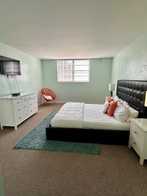 bedroom featuring dark colored carpet