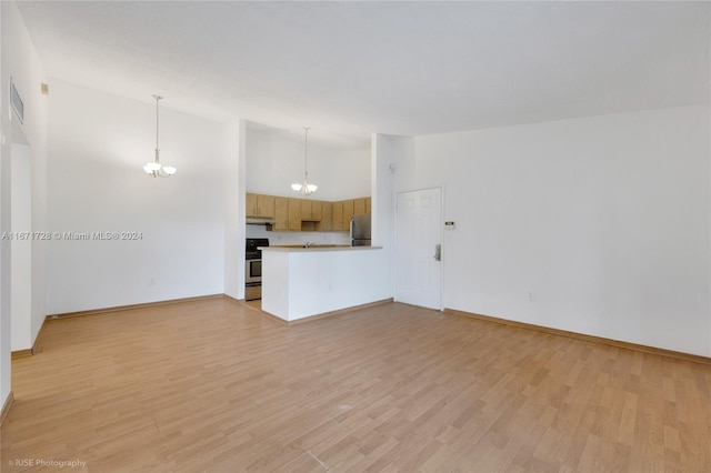 unfurnished living room with high vaulted ceiling, a chandelier, and light hardwood / wood-style flooring