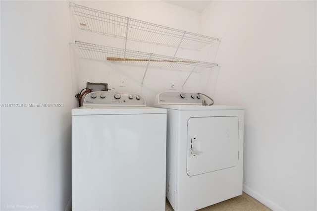 laundry room with washer and clothes dryer and carpet