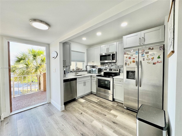 kitchen with a healthy amount of sunlight, stainless steel appliances, and white cabinetry