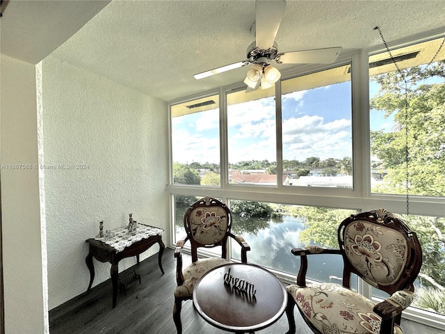 sunroom with a healthy amount of sunlight and ceiling fan