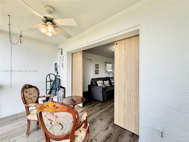 corridor featuring hardwood / wood-style floors and a textured ceiling