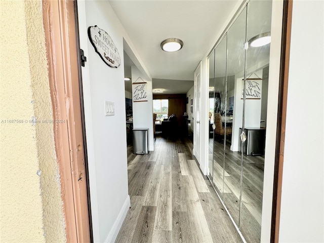 corridor with hardwood / wood-style floors