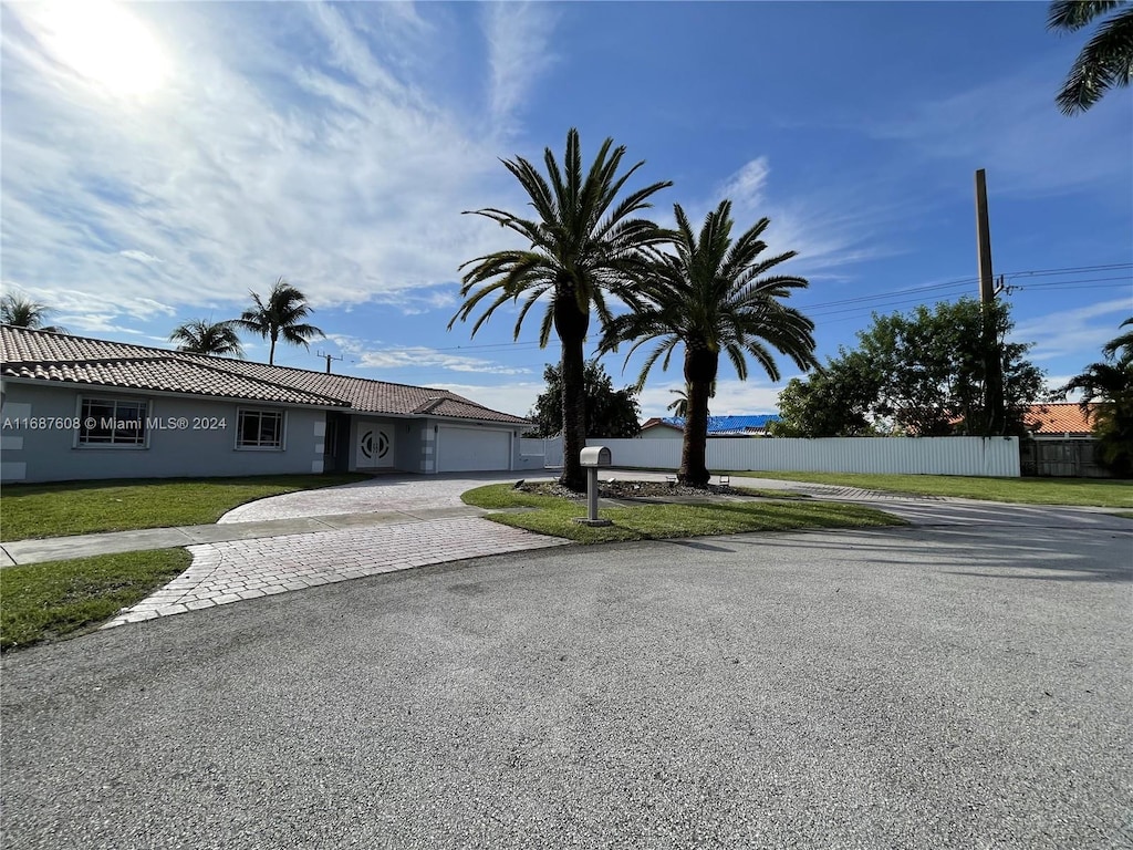 view of front facade with a garage and a front lawn