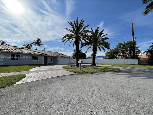 view of front facade with a garage and a front lawn