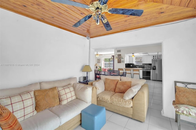 living room with lofted ceiling, light tile patterned flooring, ceiling fan, and wood ceiling