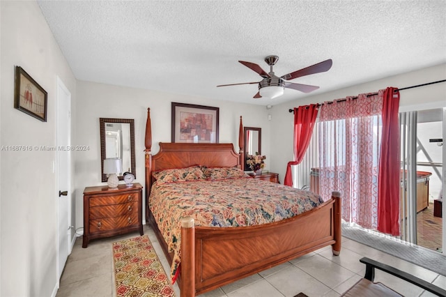 bedroom with a textured ceiling, ceiling fan, and light tile patterned floors