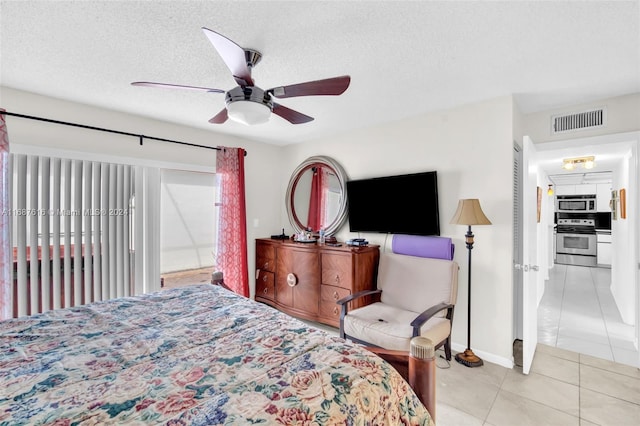 tiled bedroom featuring a textured ceiling and ceiling fan