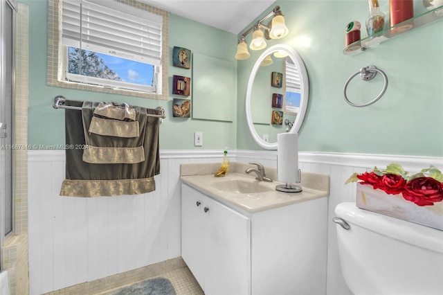 bathroom featuring toilet, vanity, and tile patterned flooring