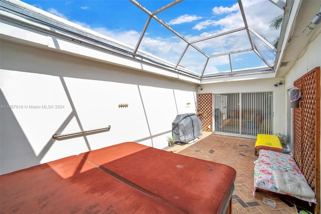 view of patio / terrace featuring grilling area and glass enclosure