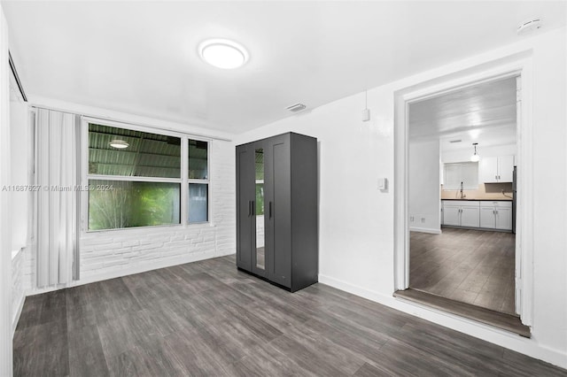 empty room featuring dark hardwood / wood-style flooring