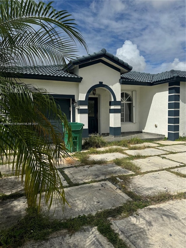 view of exterior entry featuring a garage