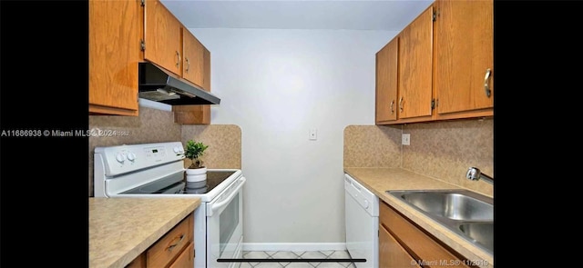 kitchen with tile patterned floors, sink, white appliances, and tasteful backsplash