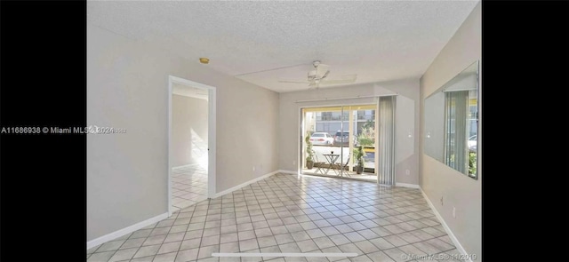 tiled spare room featuring a textured ceiling and ceiling fan