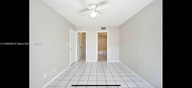 tiled spare room with ceiling fan