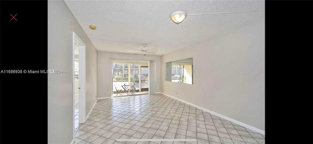 tiled spare room with ceiling fan and a textured ceiling