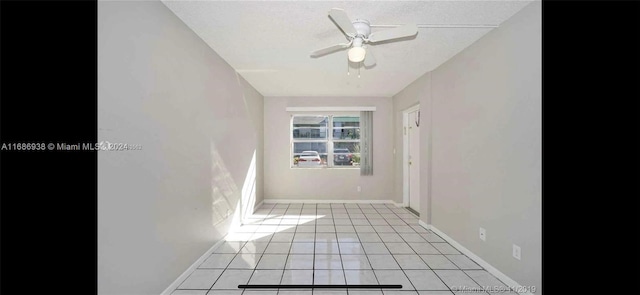 unfurnished room with a textured ceiling, light tile patterned floors, and ceiling fan