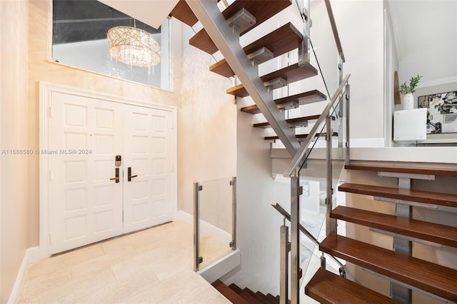 foyer entrance featuring light tile patterned flooring and an inviting chandelier