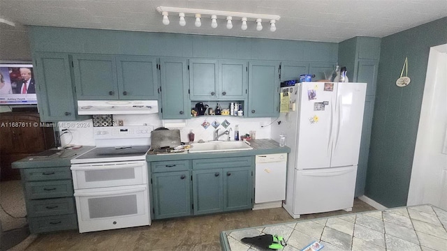 kitchen featuring white appliances, a sink, exhaust hood, open shelves, and blue cabinets
