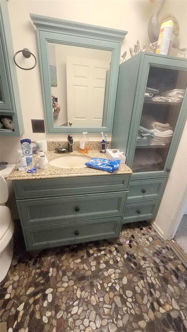 bathroom featuring toilet and vanity