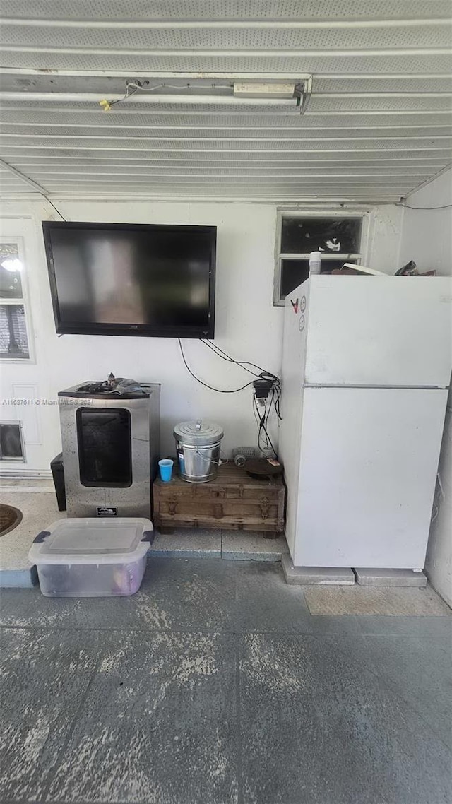 interior details featuring concrete floors and white refrigerator