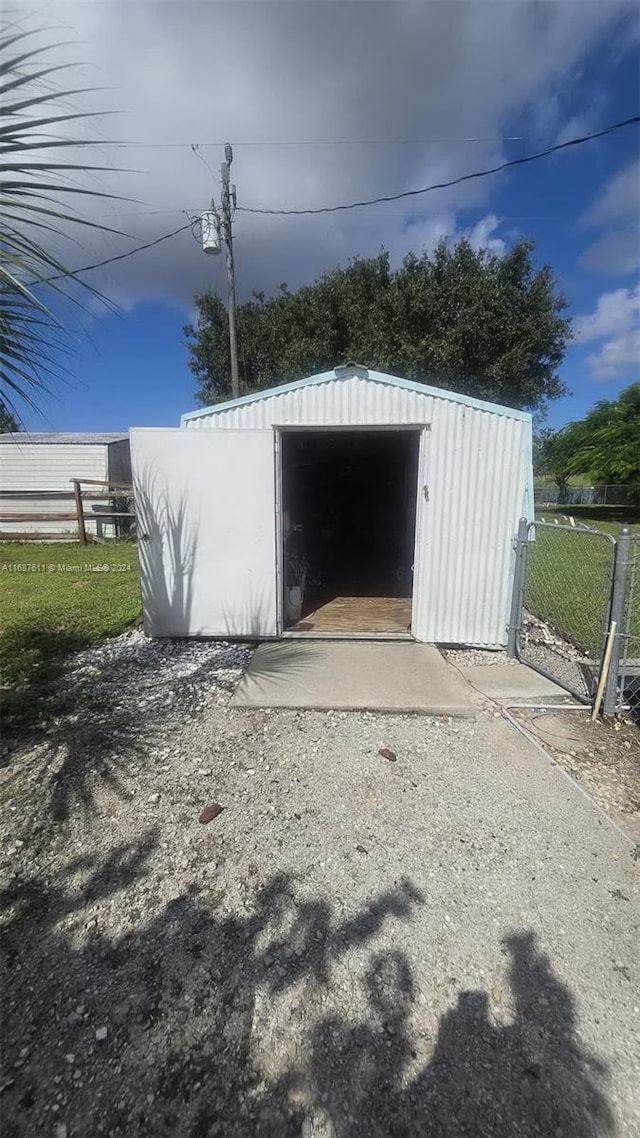 view of shed featuring fence