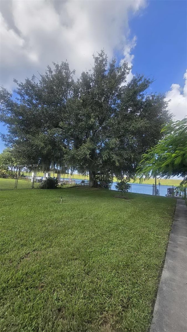 view of grassy yard with a water view