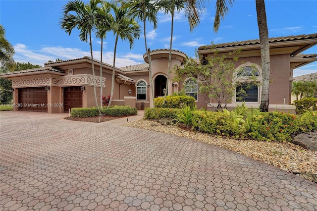 mediterranean / spanish house featuring a garage