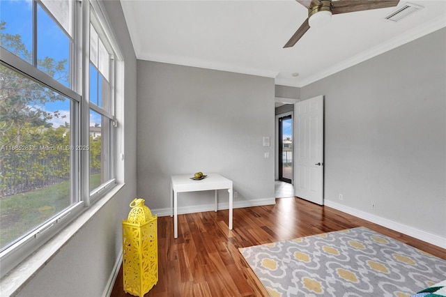 bedroom featuring wood-type flooring, ornamental molding, and ceiling fan