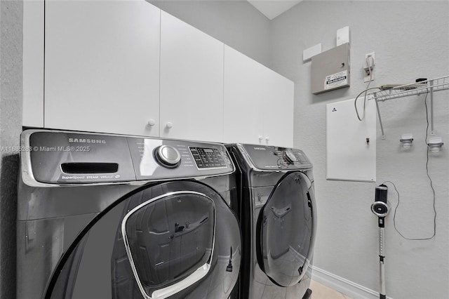 laundry area with washer and dryer and cabinets