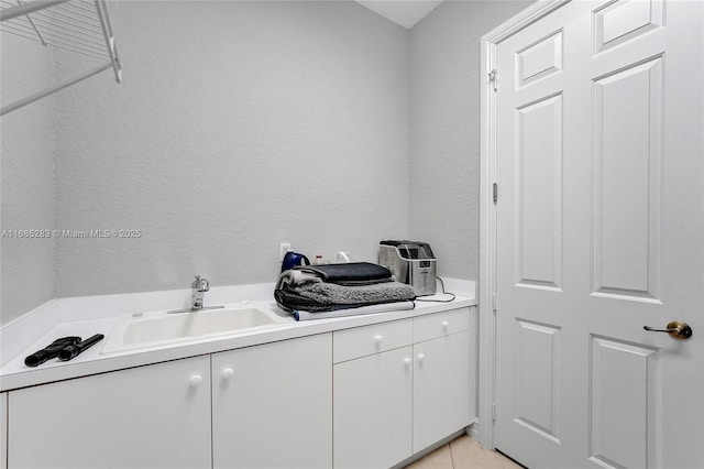 washroom with light tile patterned flooring and sink