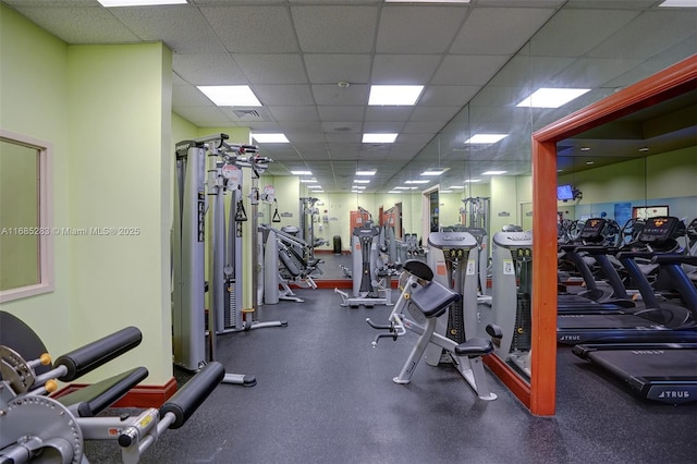 workout area featuring a paneled ceiling