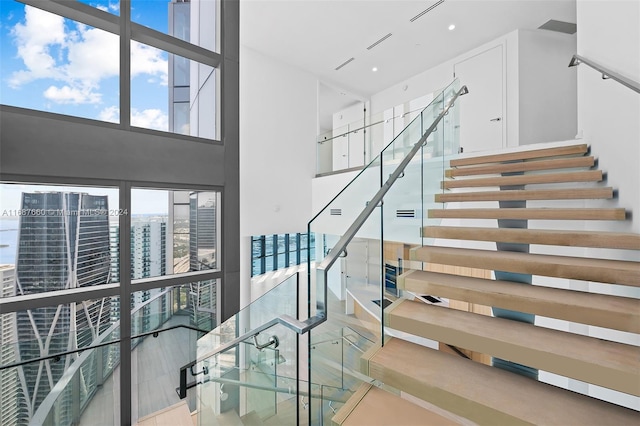 staircase with a towering ceiling