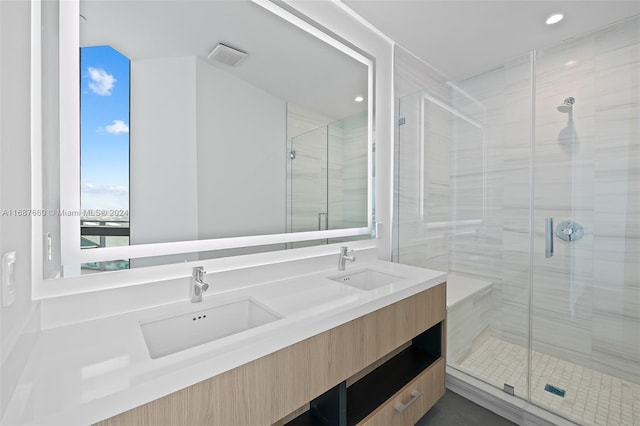 bathroom featuring vanity and a shower with shower door