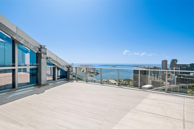 view of patio with a water view and a balcony