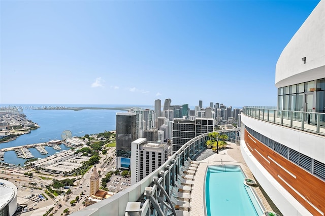 view of swimming pool featuring a water view