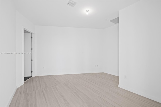 spare room featuring light wood-type flooring