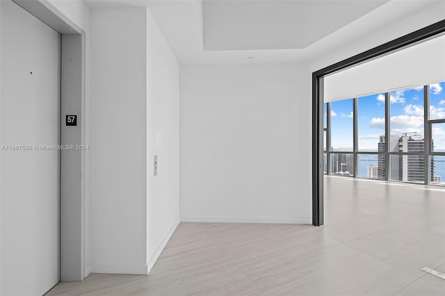 empty room with elevator and a water view