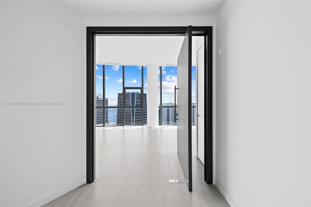 corridor with a wall of windows and a water view