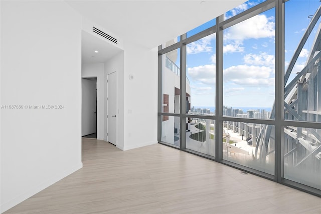 empty room featuring floor to ceiling windows and a wealth of natural light