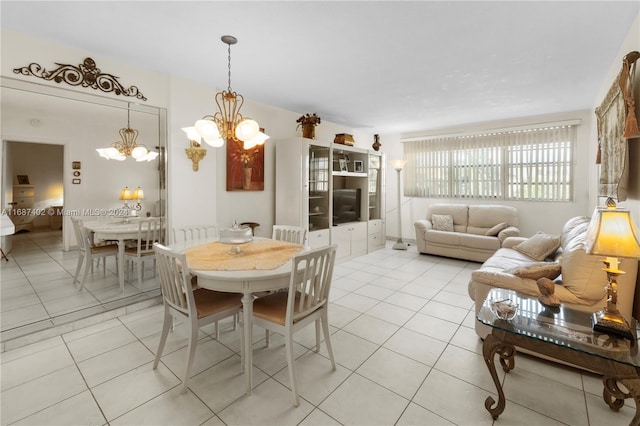 tiled dining room featuring a notable chandelier