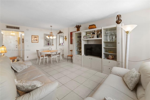 tiled living room featuring a chandelier