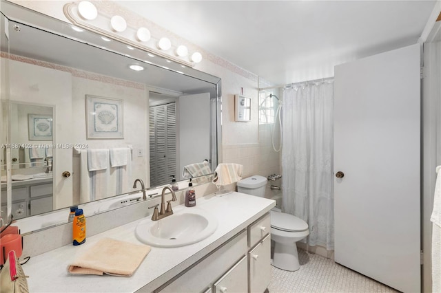 bathroom featuring walk in shower, tile walls, toilet, vanity, and tile patterned floors