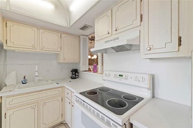 1333 E Hallandale Beach Blvd Unit 409, Hallandale Beach, FL 33009 - kitchen featuring white range with electric cooktop, under cabinet range hood, light countertops, and cream cabinetry