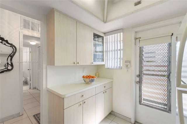 1333 E Hallandale Beach Blvd Unit 409, Hallandale Beach, FL 33009 - kitchen with light tile patterned floors, light countertops, and glass insert cabinets