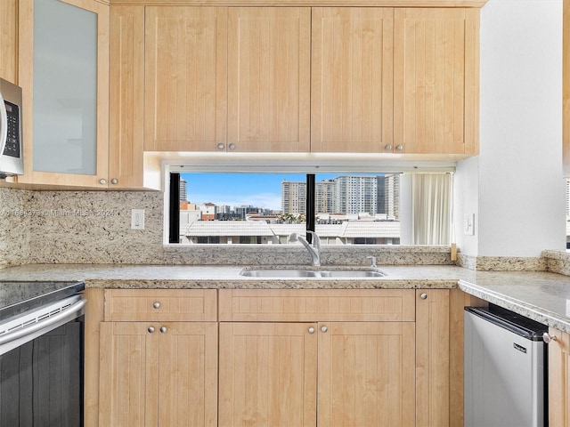 17021 N Bay Rd Unit 701, Sunny Isles Beach, FL 33160 - kitchen with light brown cabinets, appliances with stainless steel finishes, and backsplash