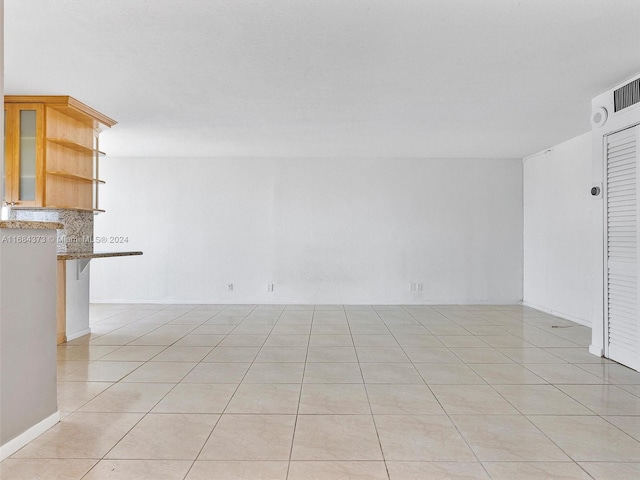 spare room with light tile patterned floors