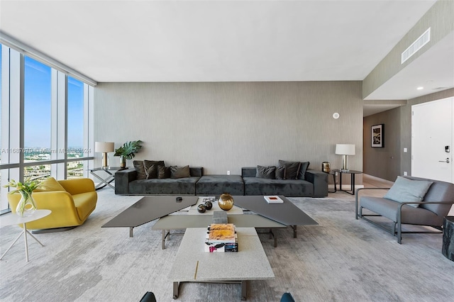 living room featuring light hardwood / wood-style floors and floor to ceiling windows