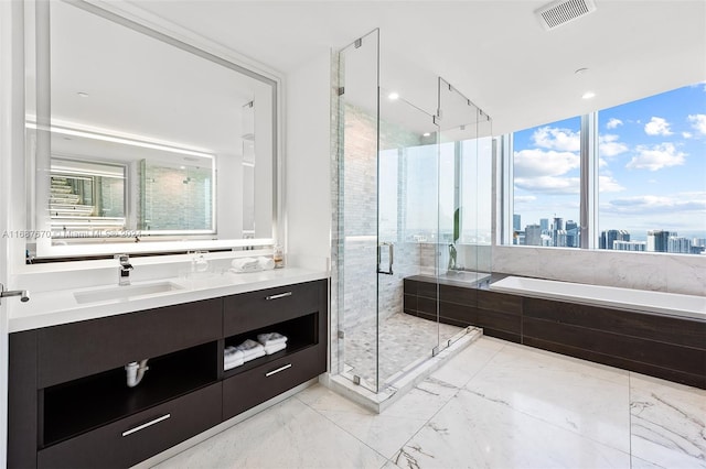 bathroom featuring vanity and separate shower and tub