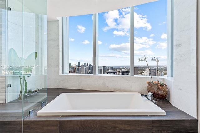 bathroom featuring a relaxing tiled tub